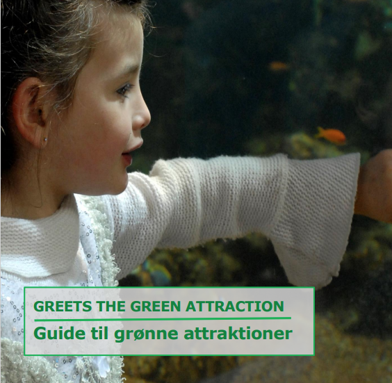 Forsiden af "Guide til grønne attraktioner". Forsiden viser et nærbillede af en pige i hvid strikbluse set fra siden, som holder den ene arm frem mod noget, og teksten "Greets the Green Attraction. Guide til grønne attraktioner".